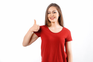Fototapeta premium Perfect app recommend. Satisfied beautiful caucasian girl shows thumb up, smiling broadly, optimistic assured gaze camera, standing white background