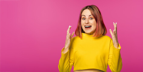 Oh my God. Amazed young woman with pink hair staring at camera with opened eyes and mouth not believing their eyes what she see. Emotional people