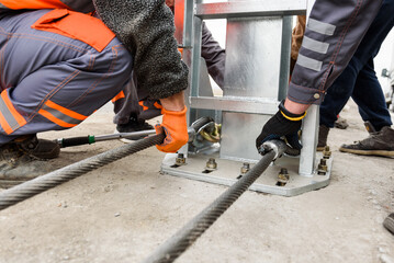Cable tensioning. Tightening of bolts nuts screw washer in concrete surface. Installation of...