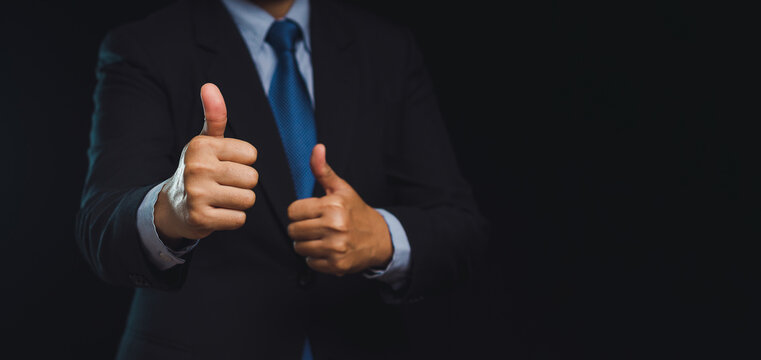 Businessman gives the client satisfaction thumbs up for the best excellent services