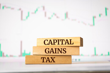Wooden blocks with words 'CAPITAL GAINS TAX'. Business concept