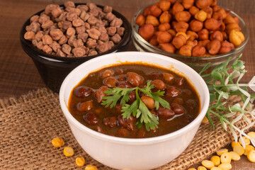 Chole masala or chana indian vegan food made of cooked chickpeas, tomatoes and cumin decorated with onion rings.