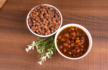 Chole masala or chana indian vegan food made of cooked chickpeas, tomatoes and cumin decorated with onion rings.