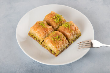 Pistachio baklava on a white plate with Turkish coffee,top view
