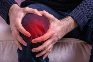 Man with knee pain. Joint pain, Arthritis and tendon problems. a man touching his pain point - obrazy, fototapety, plakaty