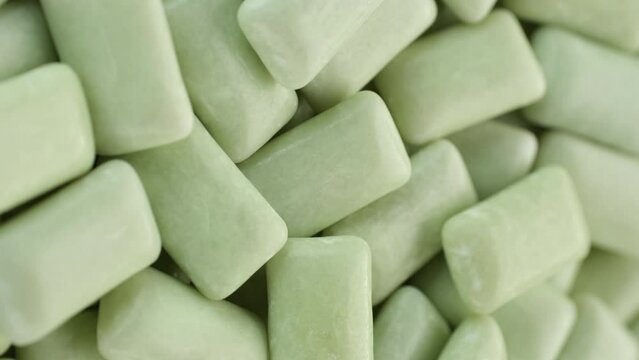 Green Mint chewing gum close up, rotation. Vertical footage