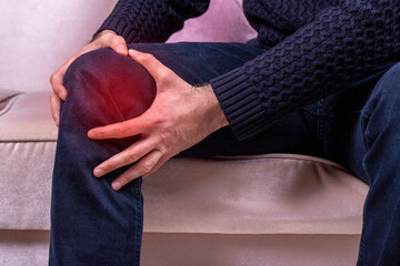 Man with knee pain. Joint pain, Arthritis and tendon problems. a man touching his pain point