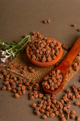 Black Chickpeas or Kala Chana with chana dal pulse isolated on wooden Background.