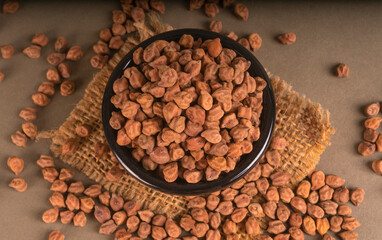 Black Chickpeas or Kala Chana with chana dal pulse isolated on wooden Background.