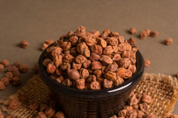 Black Chickpeas or Kala Chana with chana dal pulse isolated on wooden Background.