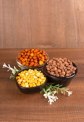 Black Chickpeas or Kala Chana with chana dal pulse isolated on wooden Background.