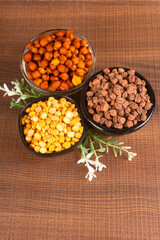 Black Chickpeas or Kala Chana with chana dal pulse isolated on wooden Background.