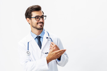 Man portrait doctor in white coat and eyeglasses and stethoscope looking into camera shows hands on background on white isolated background, space for copy, space for text, health