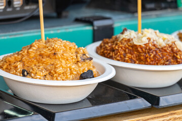 Rice dishes on the counter of a van at a food truck fair from Thailand.