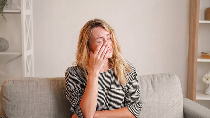 Sorrowful situation. Sad woman. Regrets depression. Despair confused lady cleaning tears with hand...