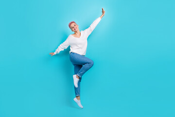 Fototapeta na wymiar Full body size cadre of careless girl flying air jumping hands creative wings wear casual stylish outfit chill isolated on cyan color background