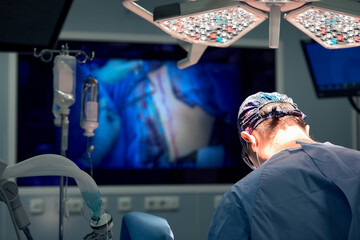 The surgeon in the operating room makes an operation looking into the monitor, modern surgery...
