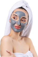 A woman with a gray clay cosmetic mask in a white towel on her head on a white background.