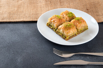 Pistachio Turkish baklava on a white plate.Traditional delicious Turkish baklava 