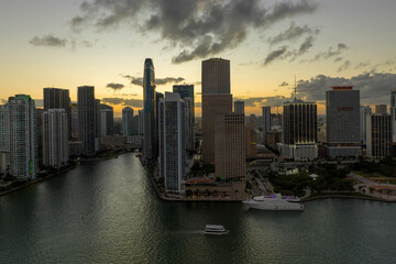 Obraz premium Aerial view of downtown district of of Miami Brickell in Florida, USA at sunset. High commercial and residential skyscraper buildings in modern american megapolis