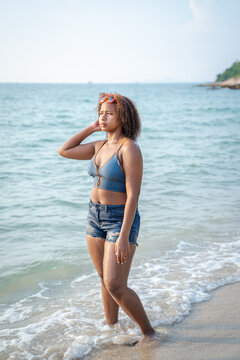 Portrait of black beautiful teenage girl having fun on sea beach,Summer vacation,Sunny hot summer day at tropical ocean beach.