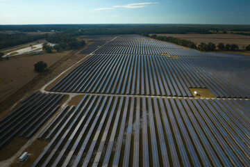 Aerial view of large sustainable electrical power plant with rows of solar photovoltaic panels for producing clean electric energy. Concept of renewable electricity with zero emission