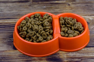 Bowl with pet food on a wooden background