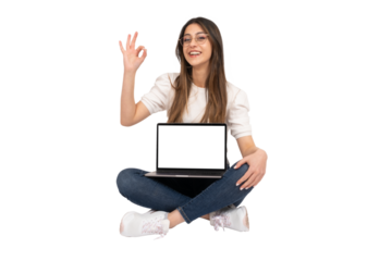 Laptop mock up, young girl sitting on the ground and holding laptop mock up. Recommending web site,  gesturing ok sign with her hand. New application, advertising, modern technology concept idea. 