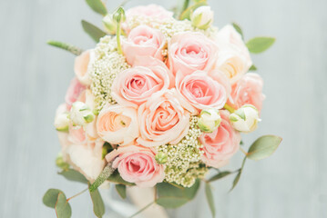 Beautiful bouquet of pink roses and ranunculus. stylish wedding attributes of bride. Declaration of love, spring. Wedding card, Valentine. classic bride's bouquet