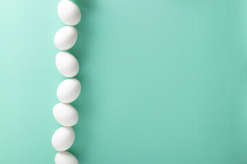 A banner with an image of a strip of eggs on a light blue background. Space for text. Minimalism.