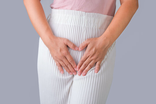 Woman with hands on her crotch isolated on white background. Female hand holding her crotch with pelvic pain or vaginal itching. gynecological problems. Health hygiene concept