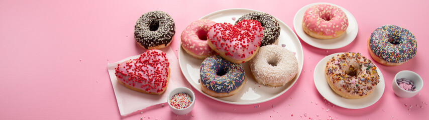 Tasty donuts on pink background. National donuts day.
