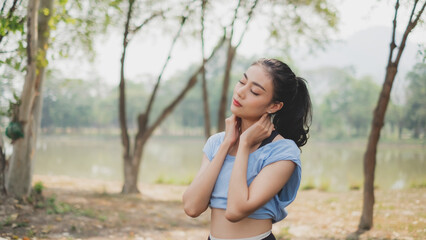 An Asian female is exercising in the morning with feeling of meditation, relaxation, calmness, concentration, comfort, zen, spiritual warm up, solitude healing and consciousness and serenity.