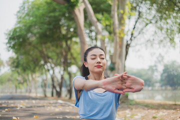 Young woman working out in early morning, practicing exercise, doing stretching out before running or jogging. Concept of healthy life, relaxation ,recreation. City life style. Body movement. warm up