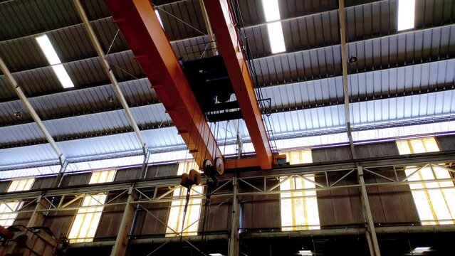 Yellow overhead crane in a factory. Large crane at a factory - Industrial videos concept