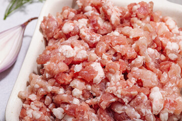 Raw minced meat, spices and herbs. Traditional ingredients for cooking cutlets or meatballs