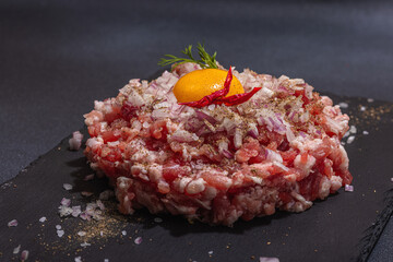 Homemade minced meat, spices and herbs. Traditional raw ingredients for cooking cutlets or meatballs