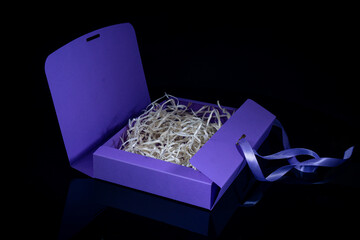 Man gift concept. Open gift box with luxury bow on dark background. Horizontal with copy space.