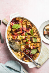 Homemade bread pudding with jam on a pink  concrete background. Selective focus, copy space