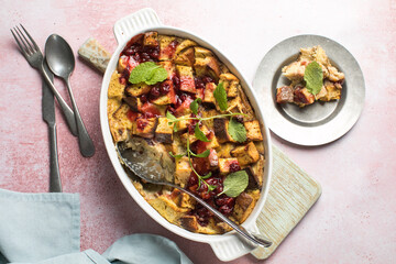 Homemade bread pudding with jam on a pink  concrete background. Selective focus, copy space