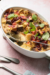Homemade bread pudding with jam on a pink  concrete background. Selective focus, copy space
