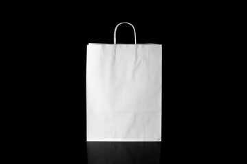 Recyclable craft paper bag for purchases, gifts and takeaway food mock up on black background. Environmentally friendly than single-use plastic bags