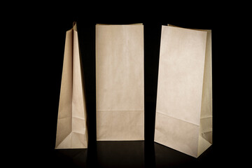 Set of paper bags for shopping on black background. Mockup for design