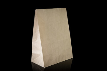 Recyclable craft paper bag for purchases, gifts and takeaway food mock up on black background. Environmentally friendly than single-use plastic bags