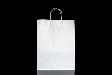 Recyclable craft paper bag for purchases, gifts and takeaway food mock up on black background. Environmentally friendly than single-use plastic bags