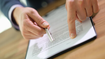 Manager giving ballpoint pen to client to signing contract document in office closeup. legal...
