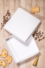 White box mockup between different sweets on the table and figures