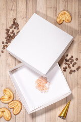 White box mockup between different sweets on the table and figures
