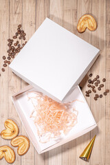 White box mockup between different sweets on the table and figures