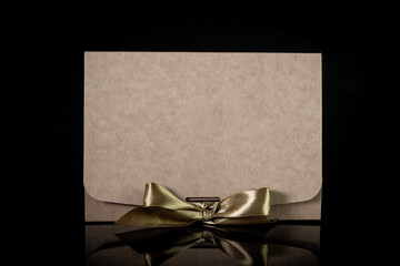 Man gift concept. gift box wrapped in craft paper with luxury bow on dark background. Horizontal with copy space.